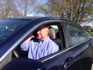 Rich Gorham takes the call from Arne Duncan while pulling up to coach track. 