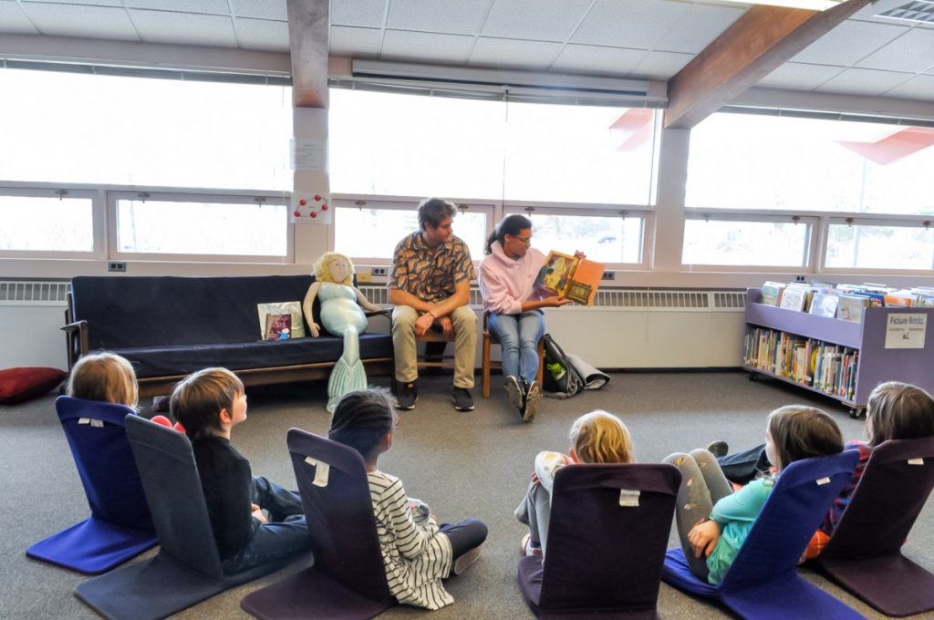 Students reading to children