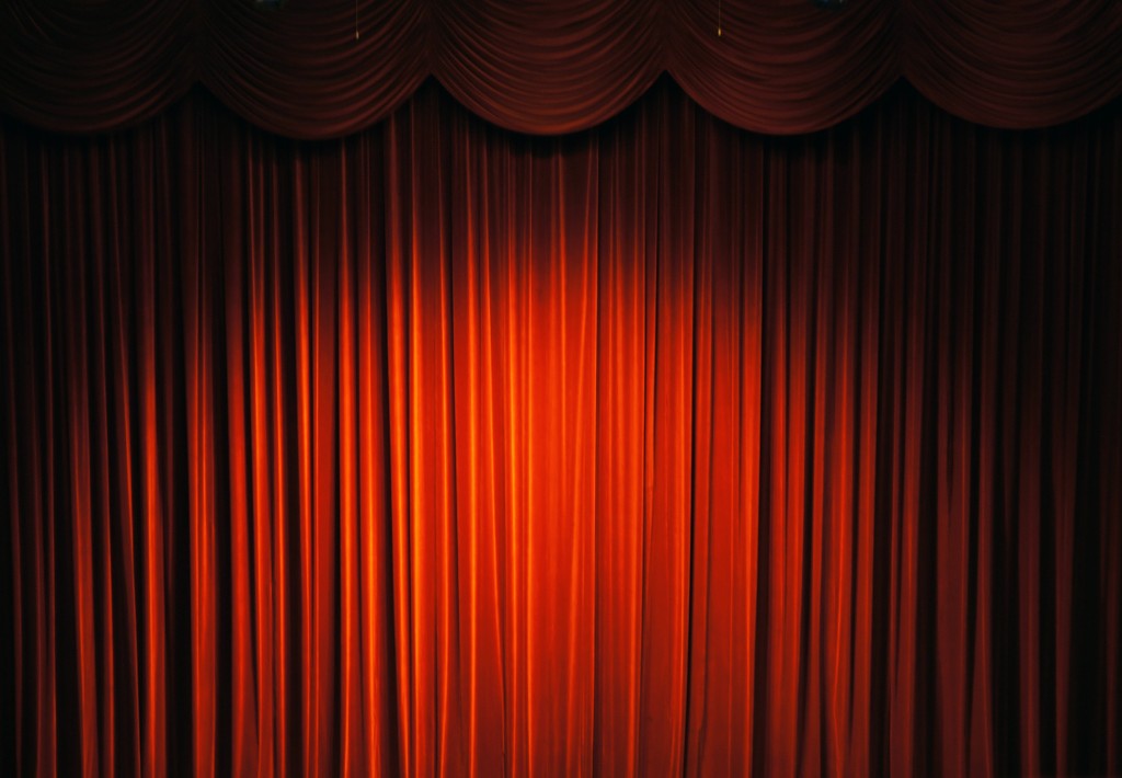 Photo of red stage curtains. 