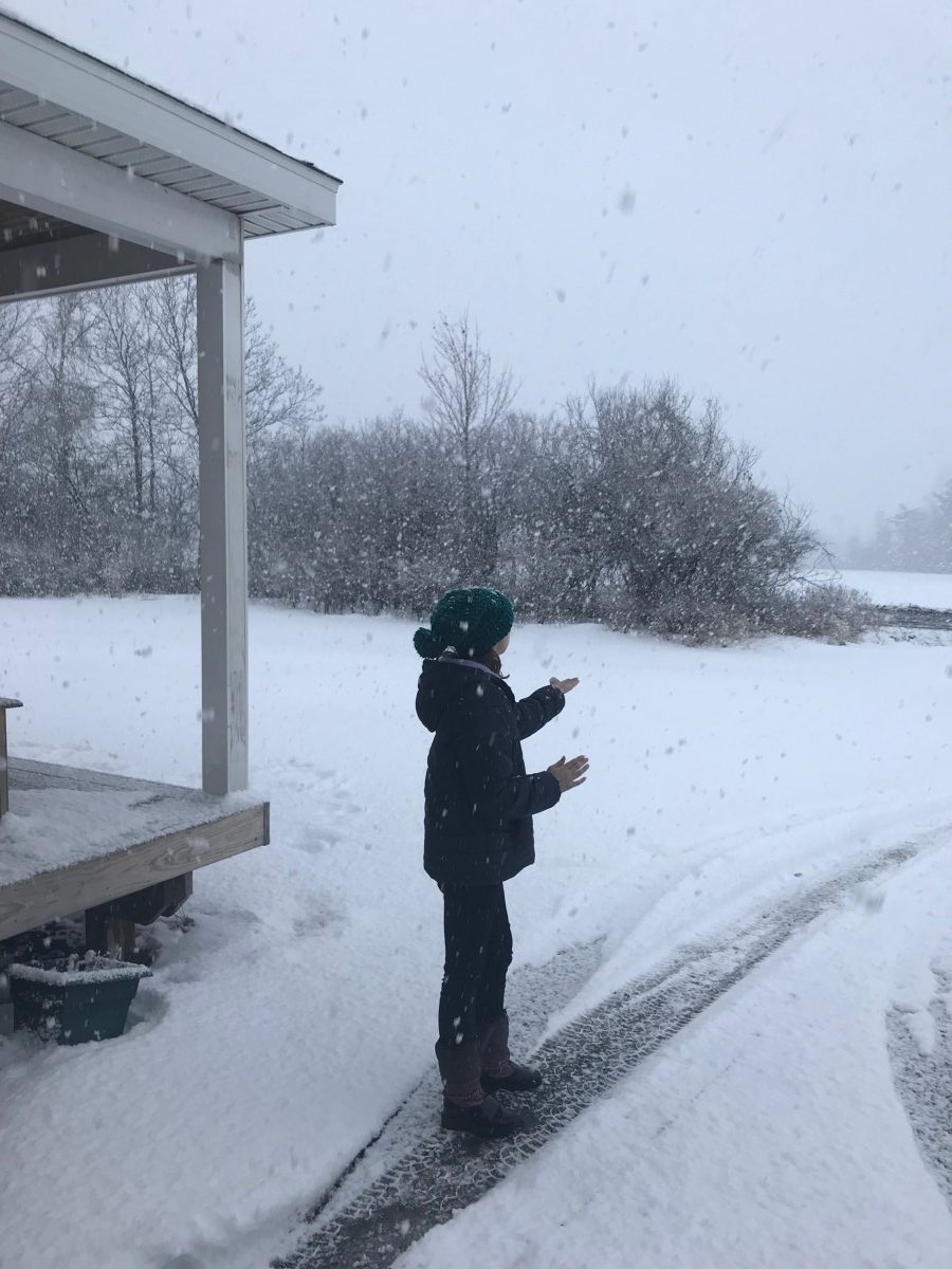 picture of a child in snowstorm catching snowflakes