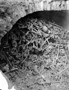 L0001903 Human bones and skulls in a brick-built pit. Photograph.