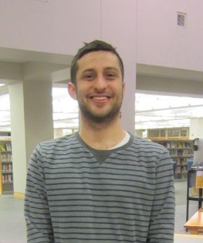 Photograph of circulation student assistant Jason Meuse standing in Davis Family Library