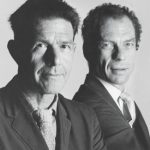 B&W portrait two men in suits: John Cage and Merce Cunningham